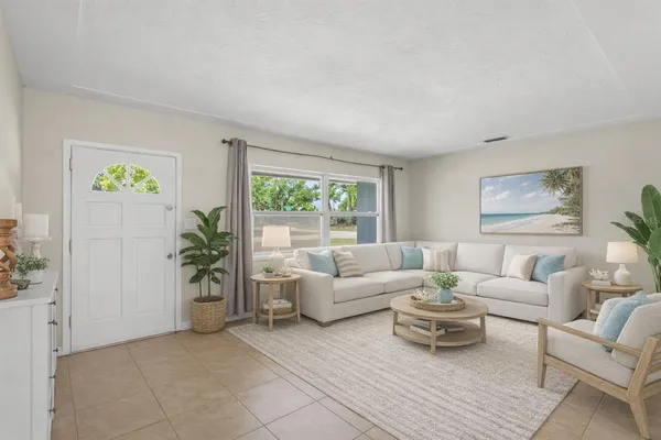 a living room with furniture and painting on the wall