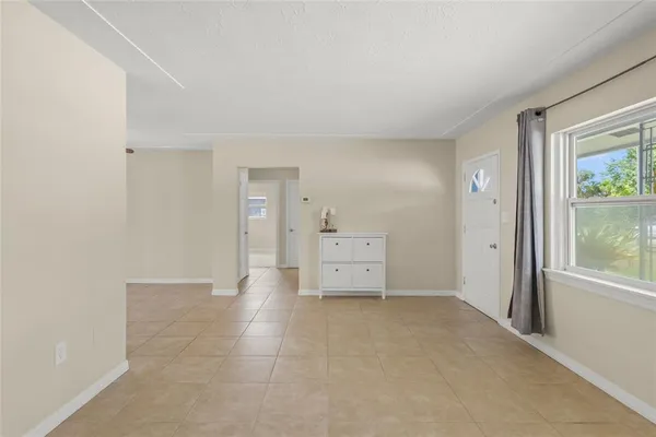 an empty room with a cabinet and mirrors