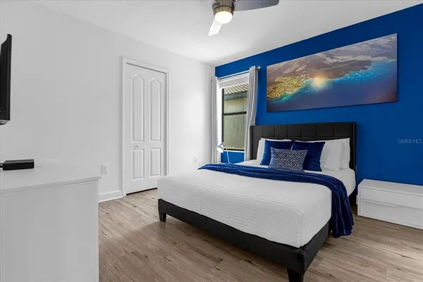 a bedroom with a bed and a flat screen tv