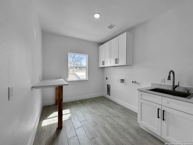 a kitchen with a sink and cabinets