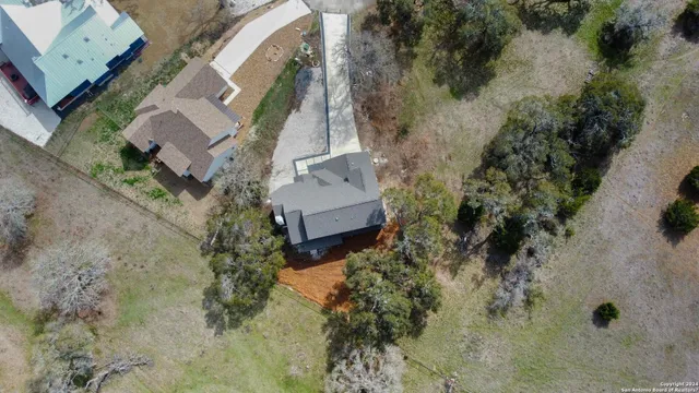 an aerial view of a house with a yard