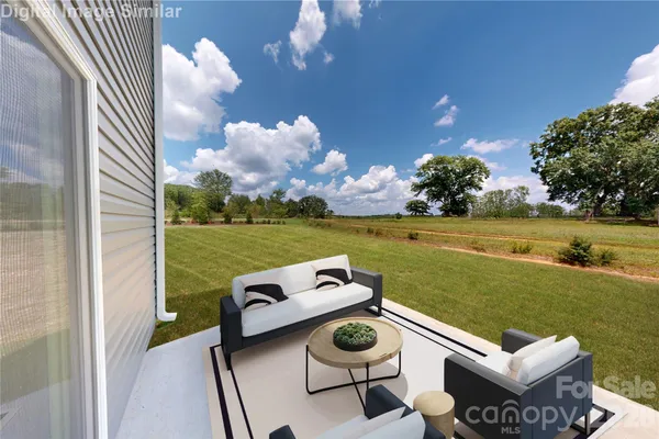 a view of a patio with lawn chairs kitchen view and a floor to ceiling window
