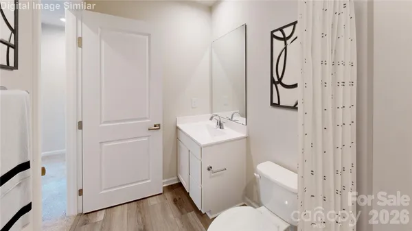 a white toilet sitting next to a bathroom sink