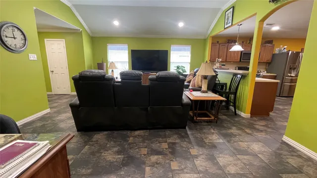 a living room with furniture and a clock