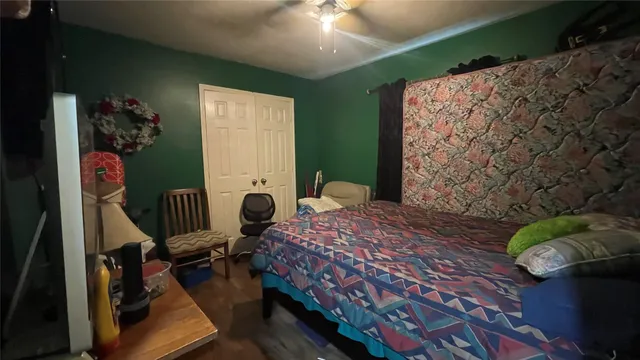 a bedroom with a bed and large windows