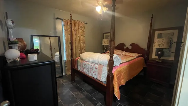 a bed room with a bed window and a dresser