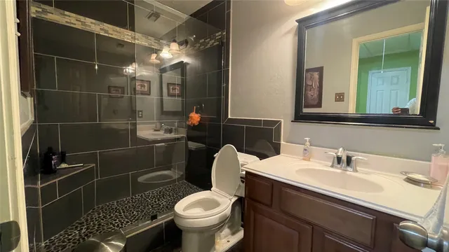a bathroom with a sink toilet and shower