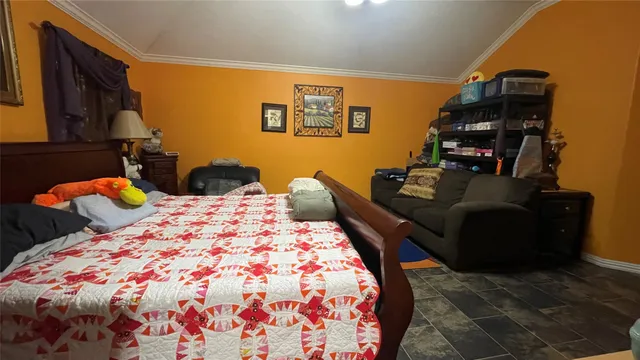 a bedroom with a bed and dresser with mirror