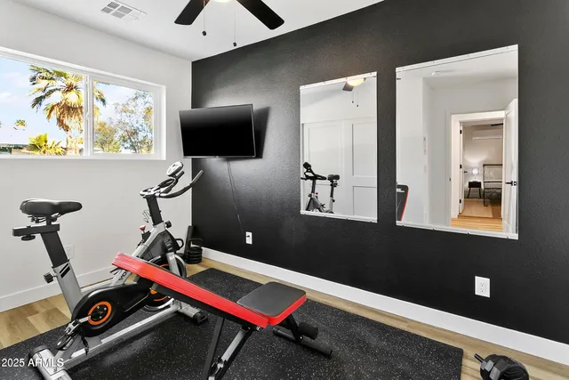 a room with gym equipment and view of living room