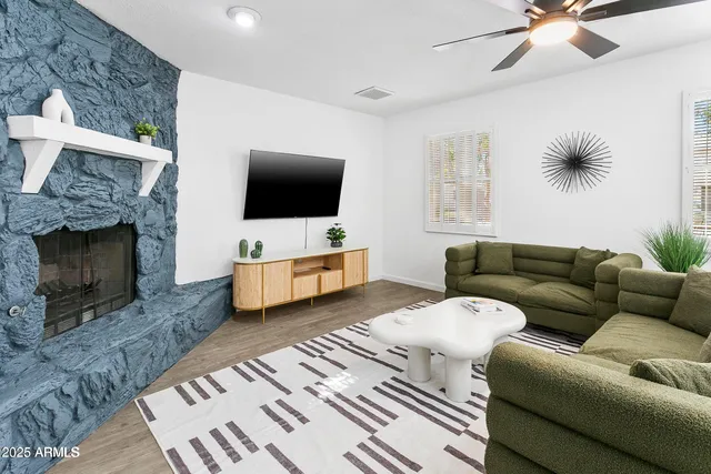 a living room with furniture and a fireplace