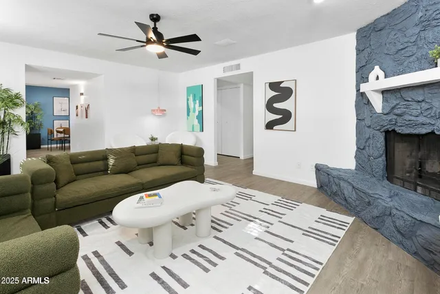 a living room with furniture and a fireplace