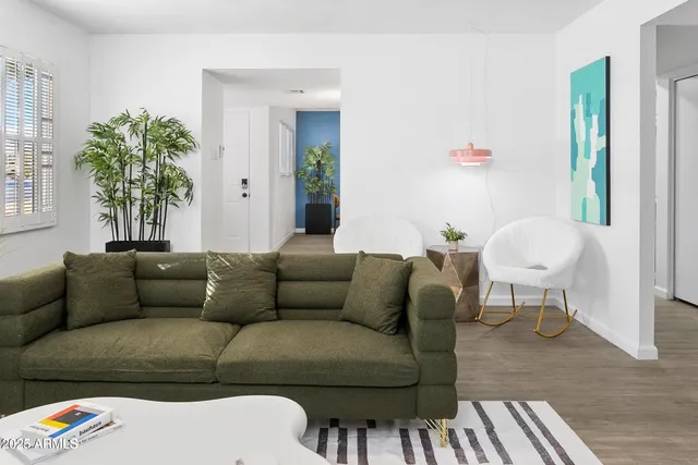 a living room with furniture and a potted plant