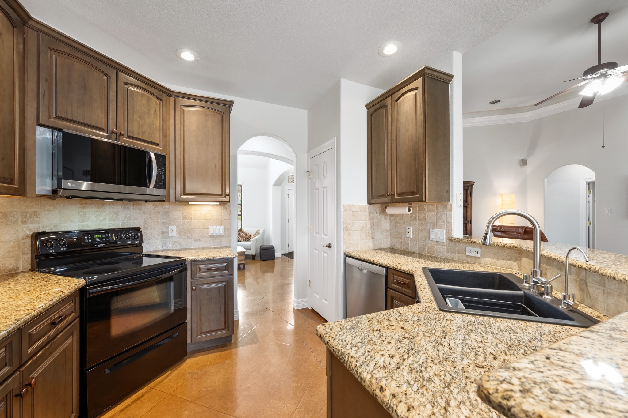 531 Leanna Oaks Loop Manchaca, TX 78652 - Photo 13 of 30 Granite counters and warm wood cabinets