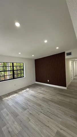 a view of an empty room and a window