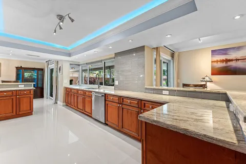 a large kitchen with stainless steel appliances granite countertop a large counter top and a stove