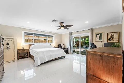 a spacious bedroom with a bed and a large window