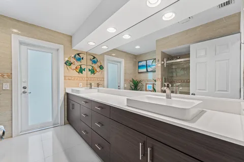 a bathroom with a sink double vanity and a mirror
