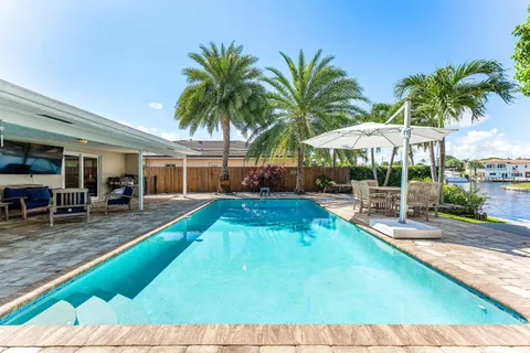 a swimming pool with outdoor seating and yard