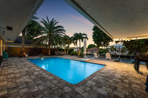 a view of a swimming pool with lounge chair