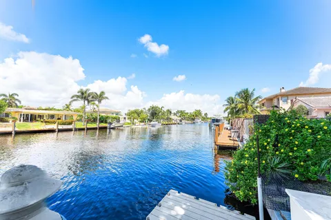 a view of a lake with lawn chairs