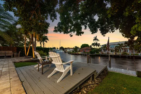 a view of a lake with chairs