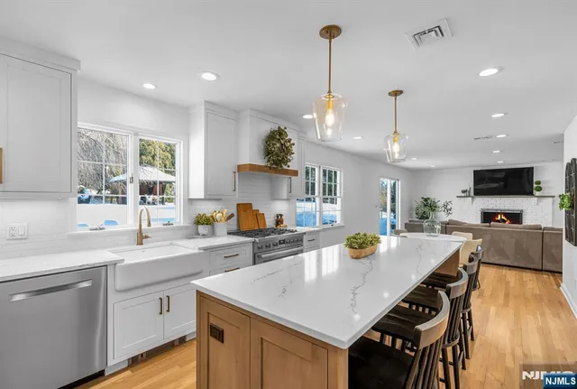 a kitchen with a sink a counter space appliances and cabinets