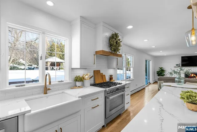 a kitchen that has a sink and a stove in it