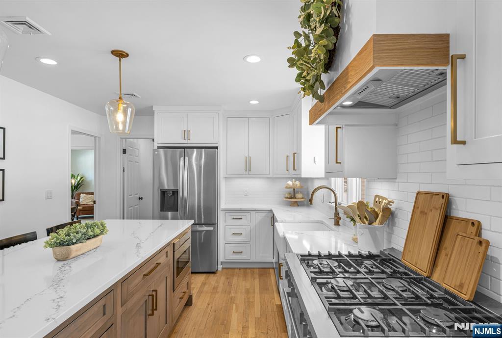 15 Cobbler Lane Mahwah, NJ 07430 - Photo 14 of 50 a kitchen with stainless steel appliances granite countertop a sink stove and refrigerator