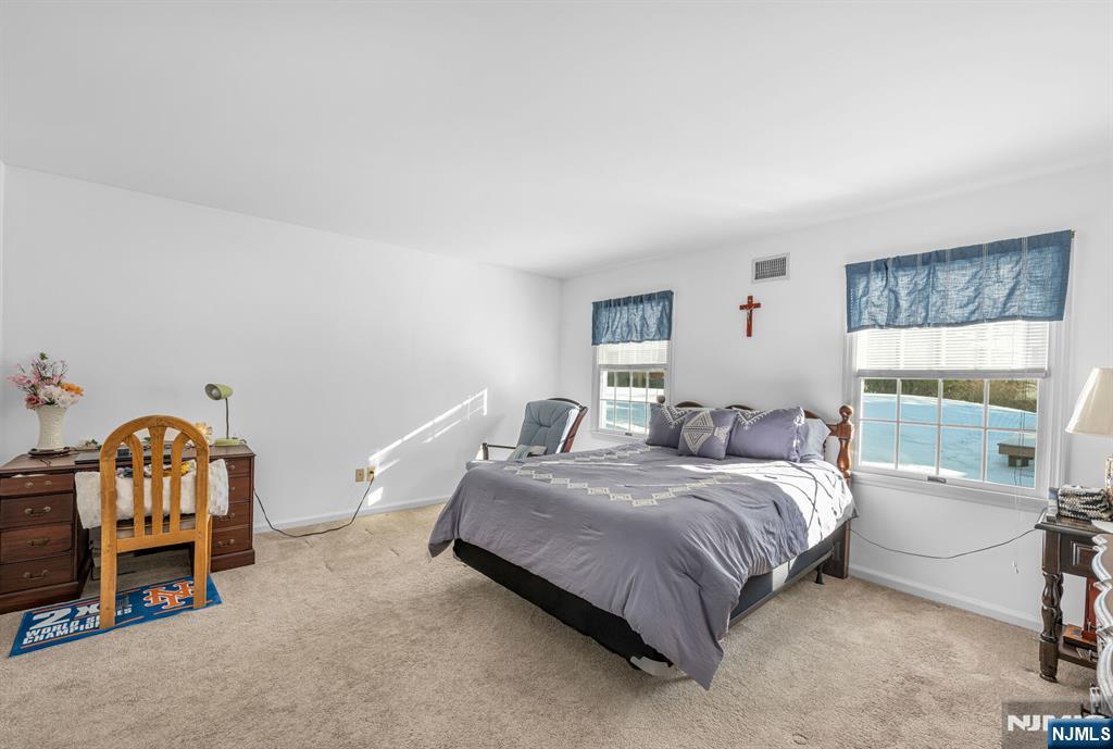 15 Cobbler Lane Mahwah, NJ 07430 - Photo 21 of 50 a bedroom with a bed and a window