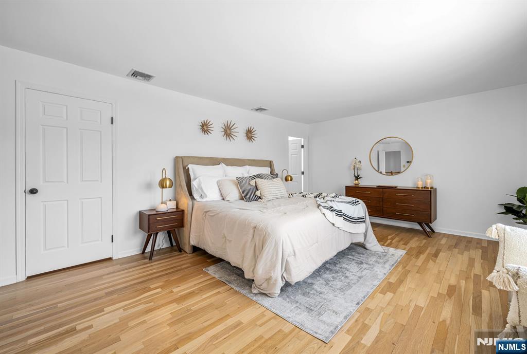 15 Cobbler Lane Mahwah, NJ 07430 - Photo 23 of 50 a bedroom with a bed and wooden floor