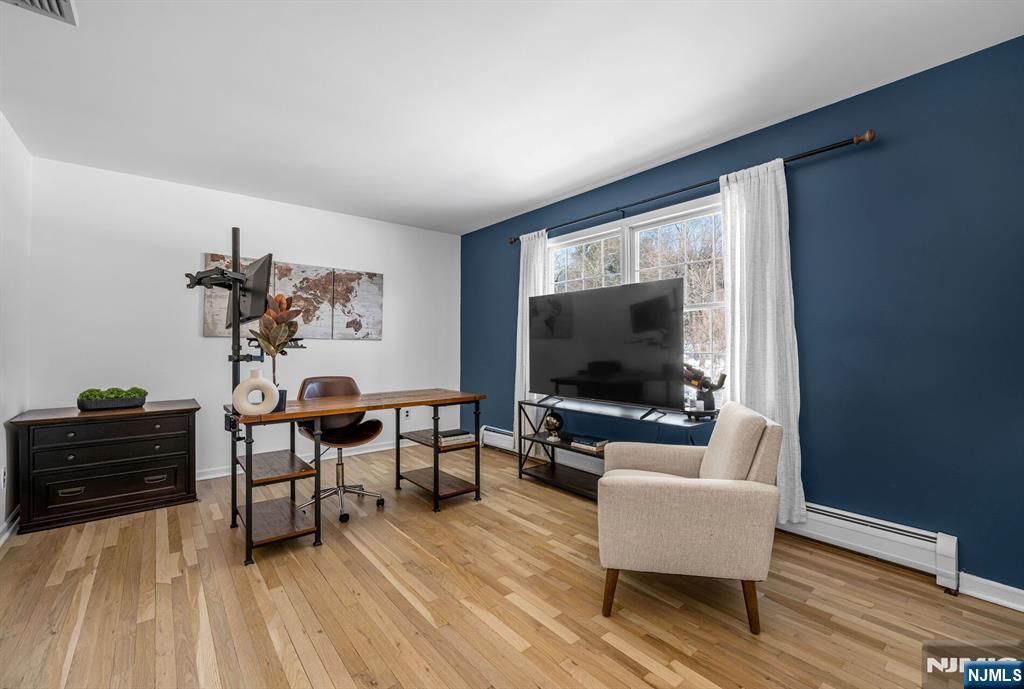 15 Cobbler Lane Mahwah, NJ 07430 - Photo 28 of 50 a living room with furniture and a flat screen tv