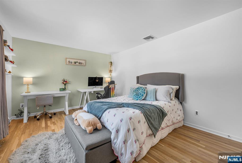 15 Cobbler Lane Mahwah, NJ 07430 - Photo 29 of 50 a bedroom with a bed and wooden floor