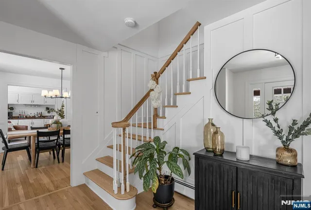 a living room with furniture a potted plant and a table