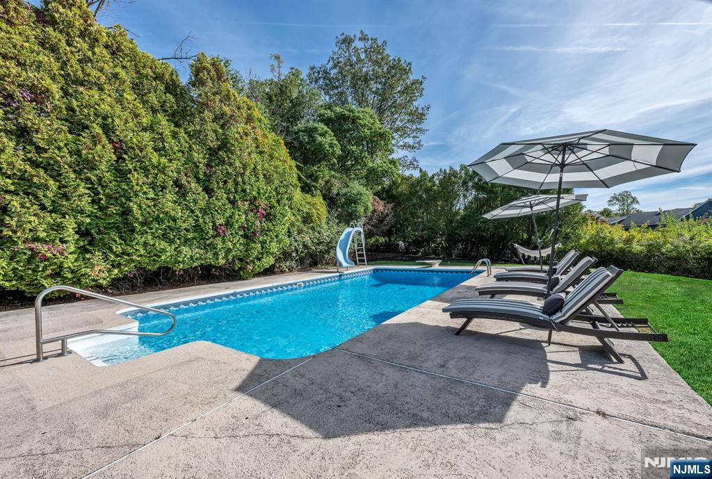 15 Cobbler Lane Mahwah, NJ 07430 - Photo 41 of 50 a swimming pool with outdoor seating and yard