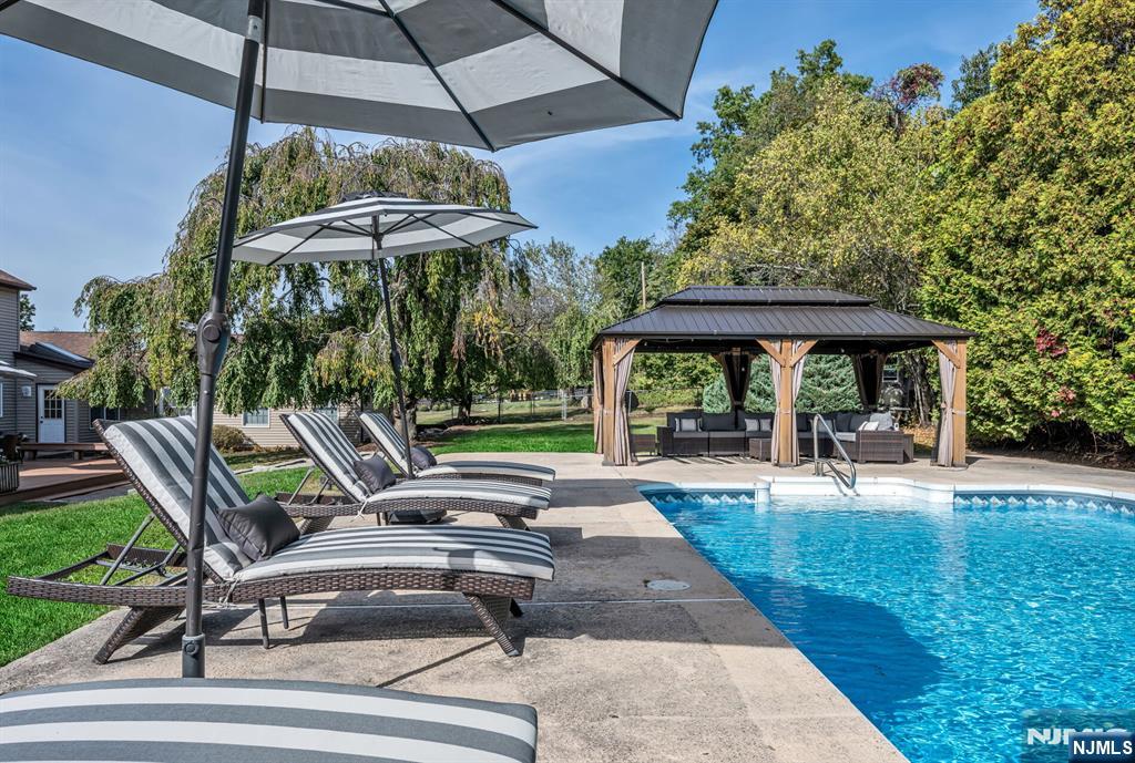 15 Cobbler Lane Mahwah, NJ 07430 - Photo 44 of 50 a view of a patio with a table chairs under an umbrella