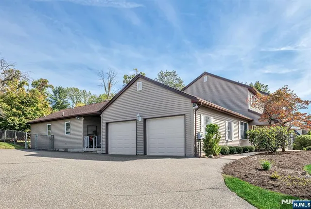 a bathroom with a sink a large mirror and a window