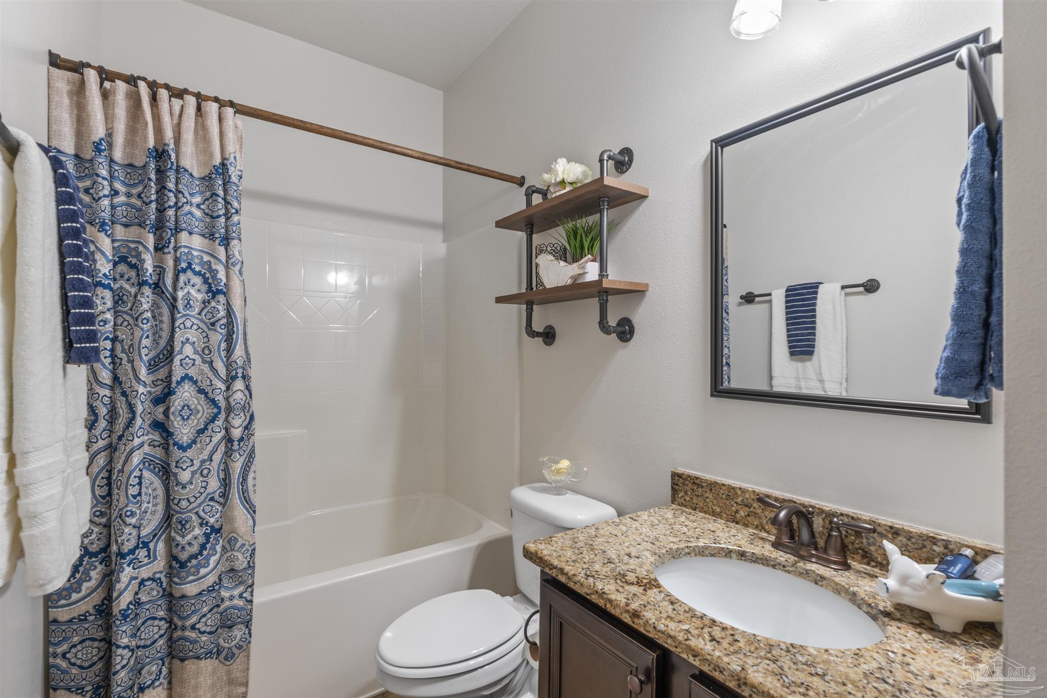 2698 Tulip Hill Road Pace, FL 32571 - Photo 37 of 65 a bathroom with a granite countertop sink toilet and shower