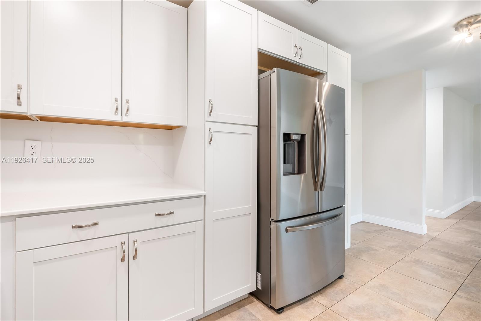 8172 Northwest 67th Avenue Tamarac, FL 33321 - Photo 12 of 44 a metallic refrigerator freezer sitting in a kitchen