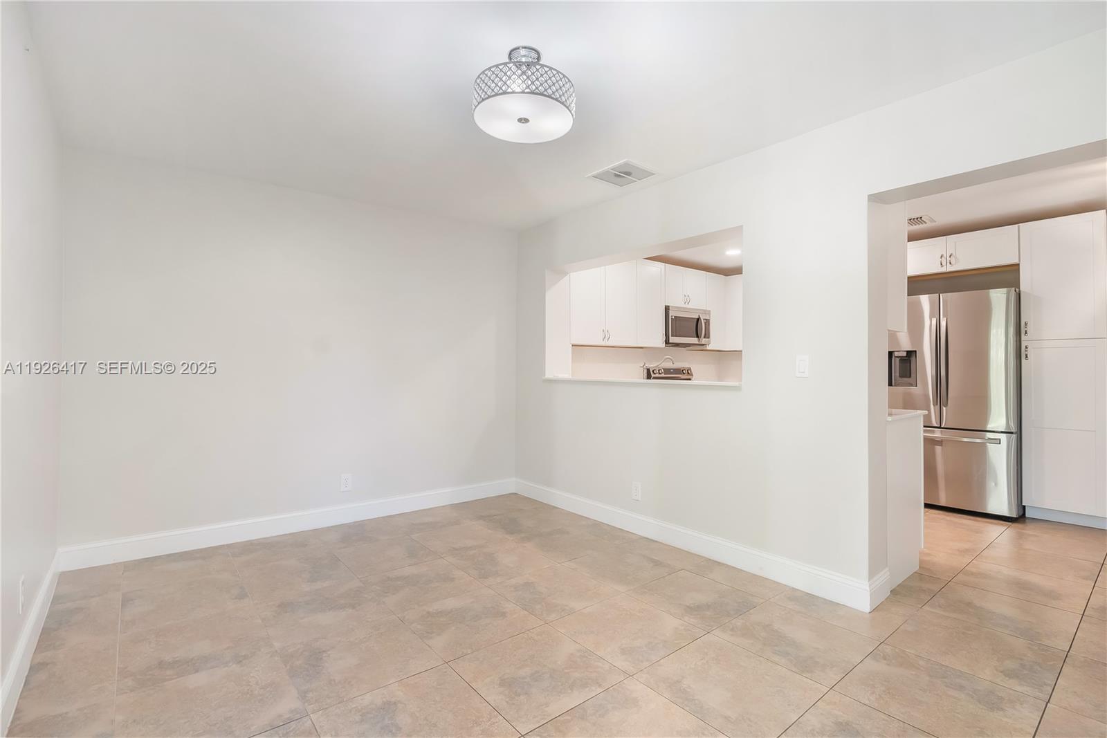 8172 Northwest 67th Avenue Tamarac, FL 33321 - Photo 13 of 44 a view of a kitchen with refrigerator and window