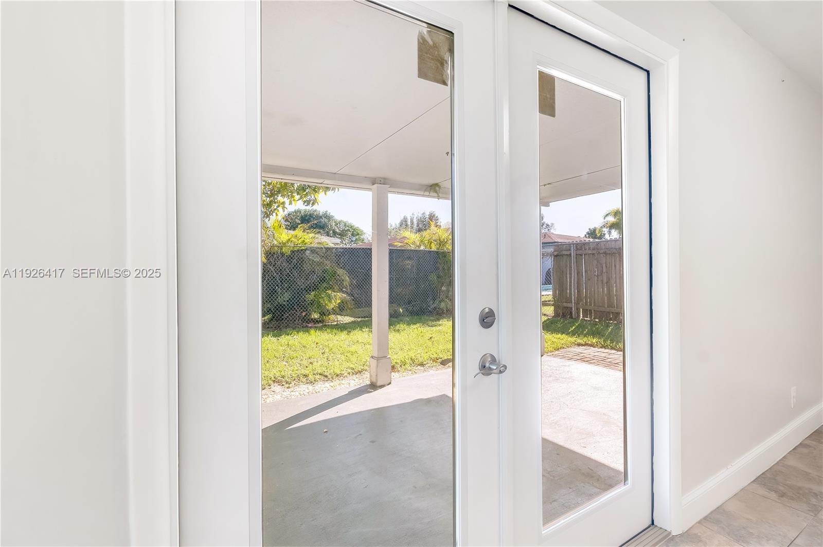 8172 Northwest 67th Avenue Tamarac, FL 33321 - Photo 24 of 44 a view of a glass door with a porch