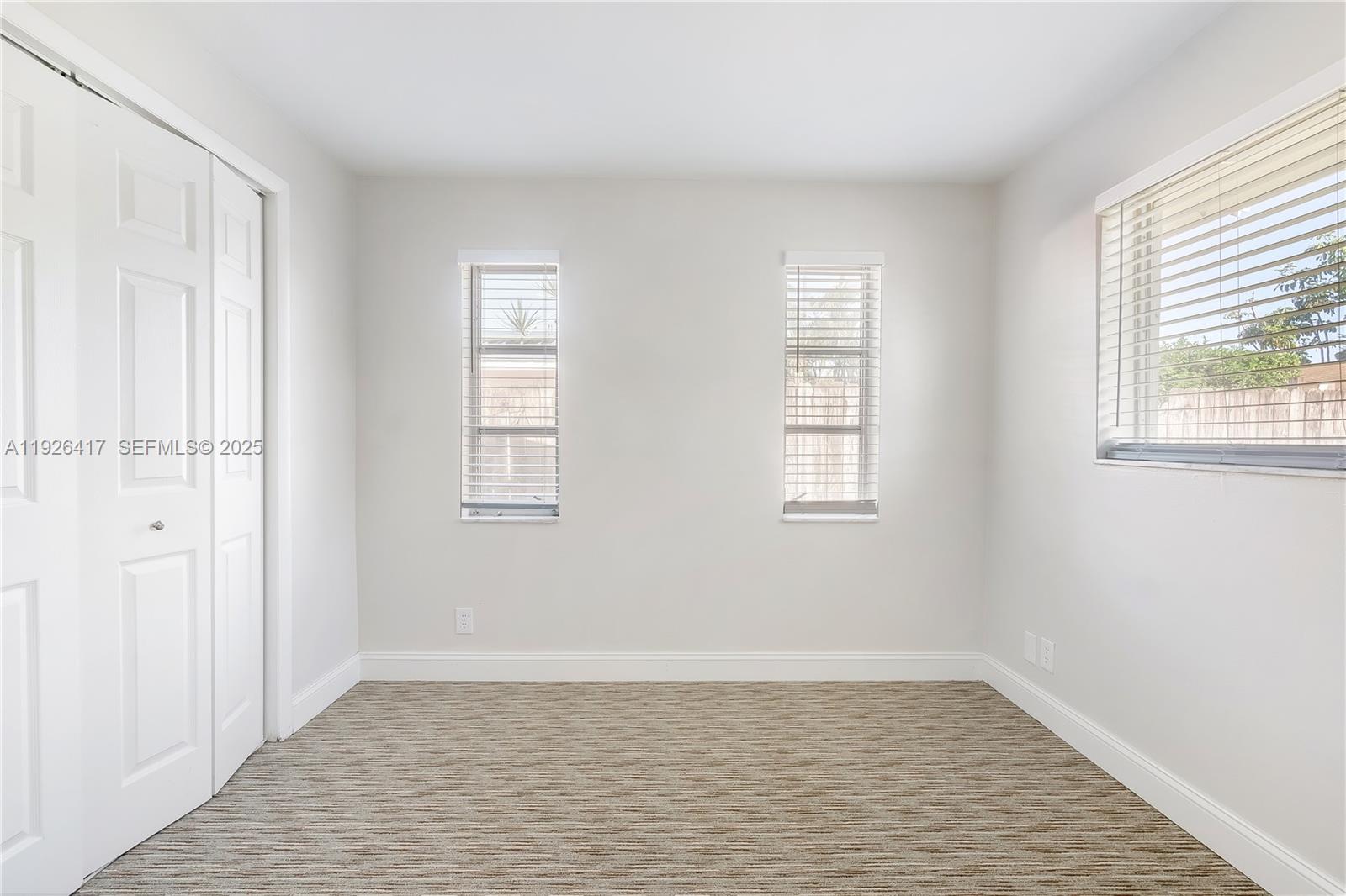 8172 Northwest 67th Avenue Tamarac, FL 33321 - Photo 32 of 44 a view of an empty room with wooden floor and a window