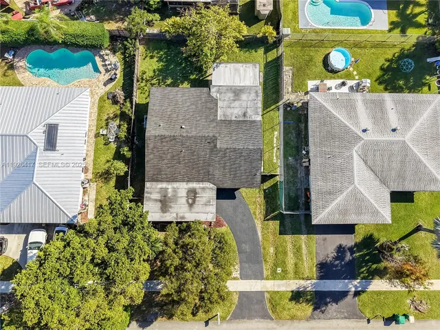 an aerial view of a house with a yard