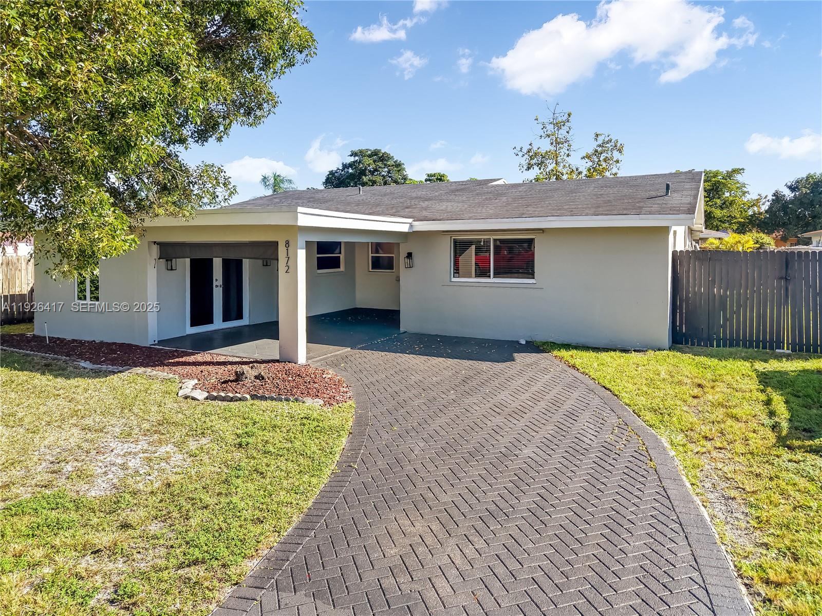 8172 Northwest 67th Avenue Tamarac, FL 33321 - Photo 44 of 44 a front view of a house with a yard