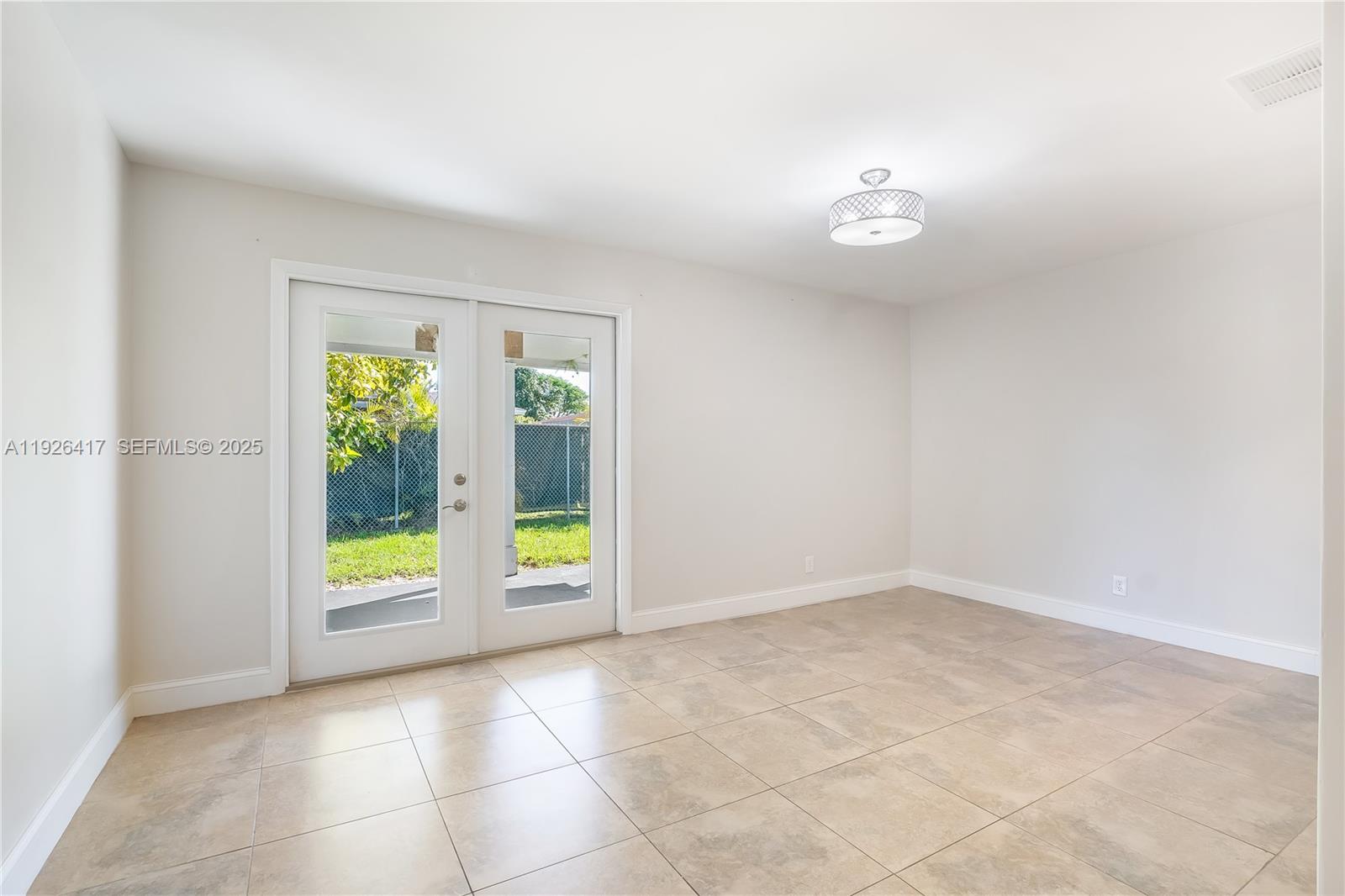 8172 Northwest 67th Avenue Tamarac, FL 33321 - Photo 7 of 44 an empty room with floor to ceiling windows and outdoor view