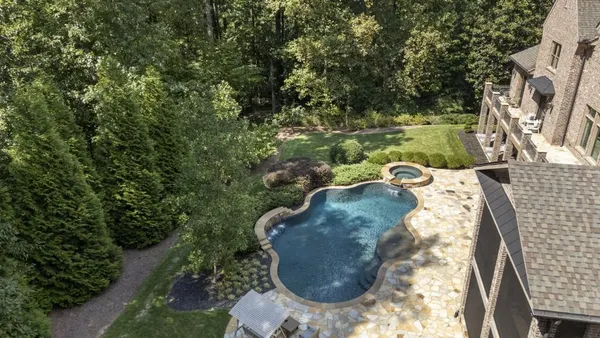 a living room with furniture a fireplace and a large window