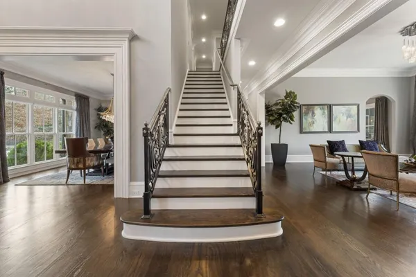 a bathroom with a granite countertop sink a potted plant and a mirror