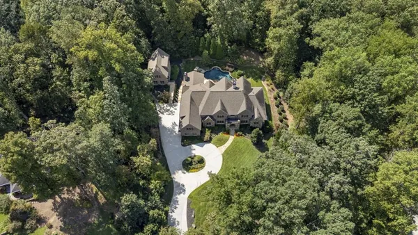 a dining room with furniture a chandelier and wooden floor