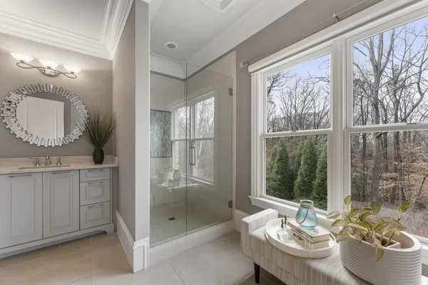 a living room with furniture a flat screen tv and a large window