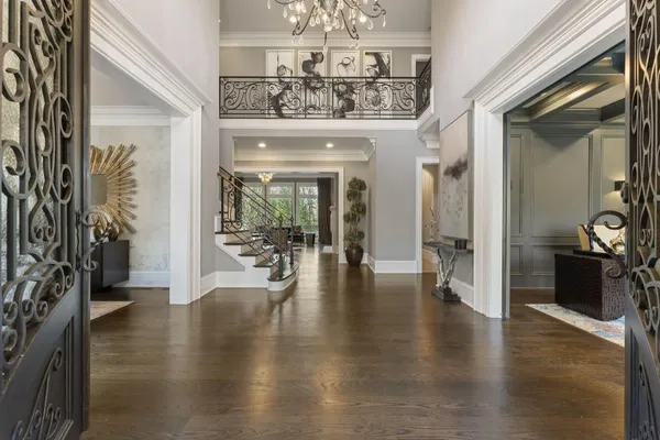 a living room with furniture a chandelier and a fireplace