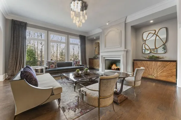 a dining room with furniture a chandelier and window